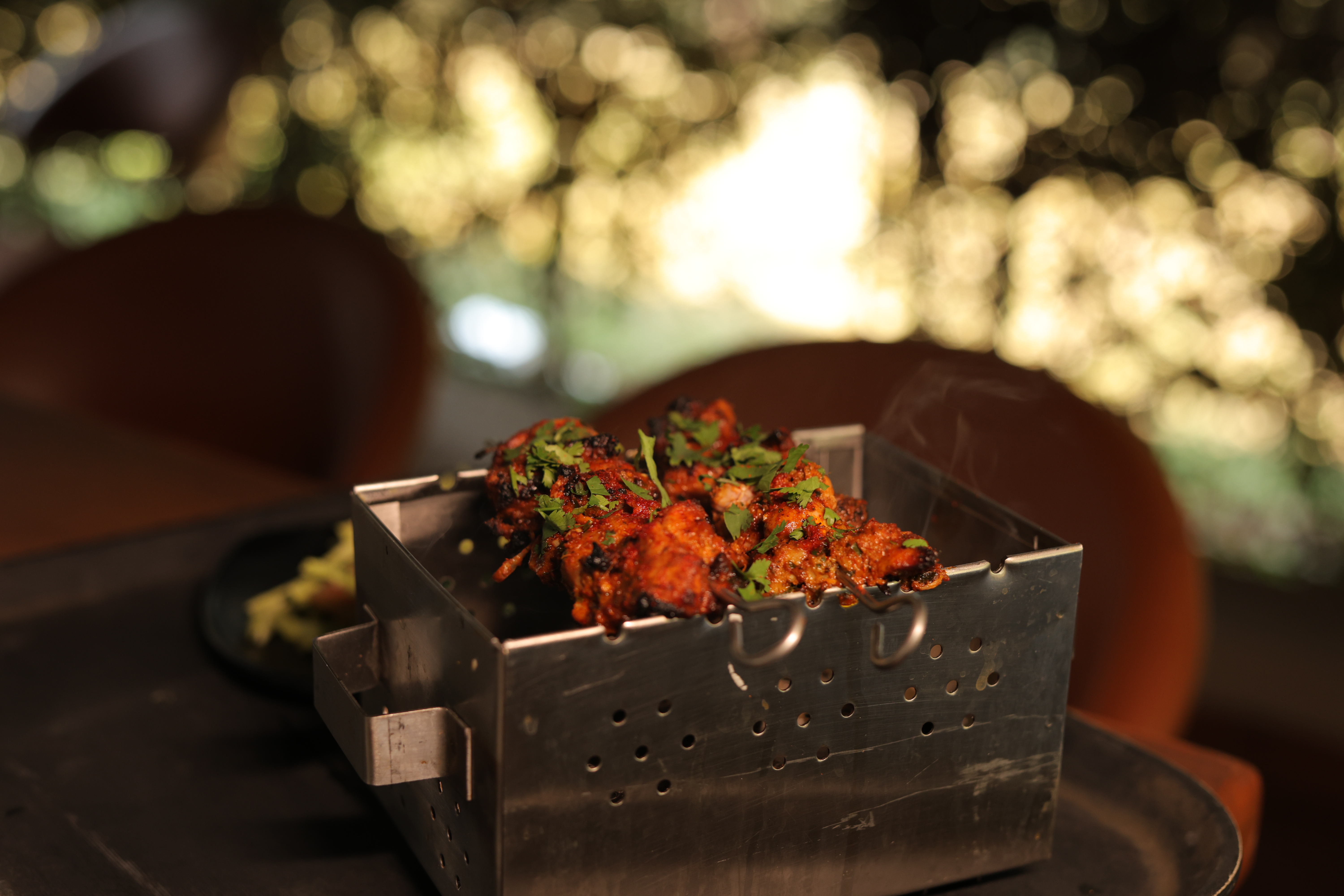 Smoky chicken tikka served in a hot coal box at Jatra Countryside