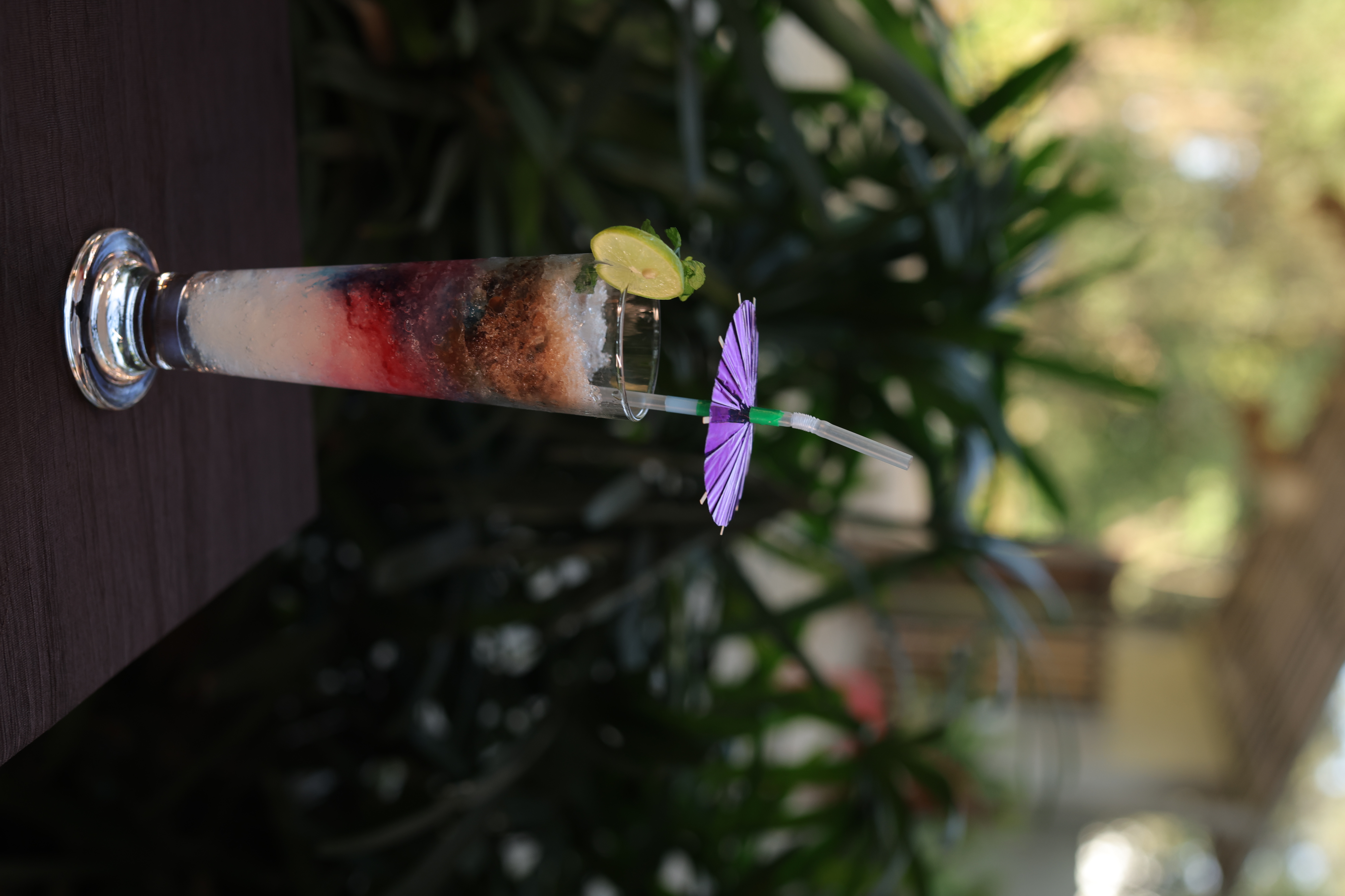 Layered gradient mocktail with paper umbrella at Jatra Countryside