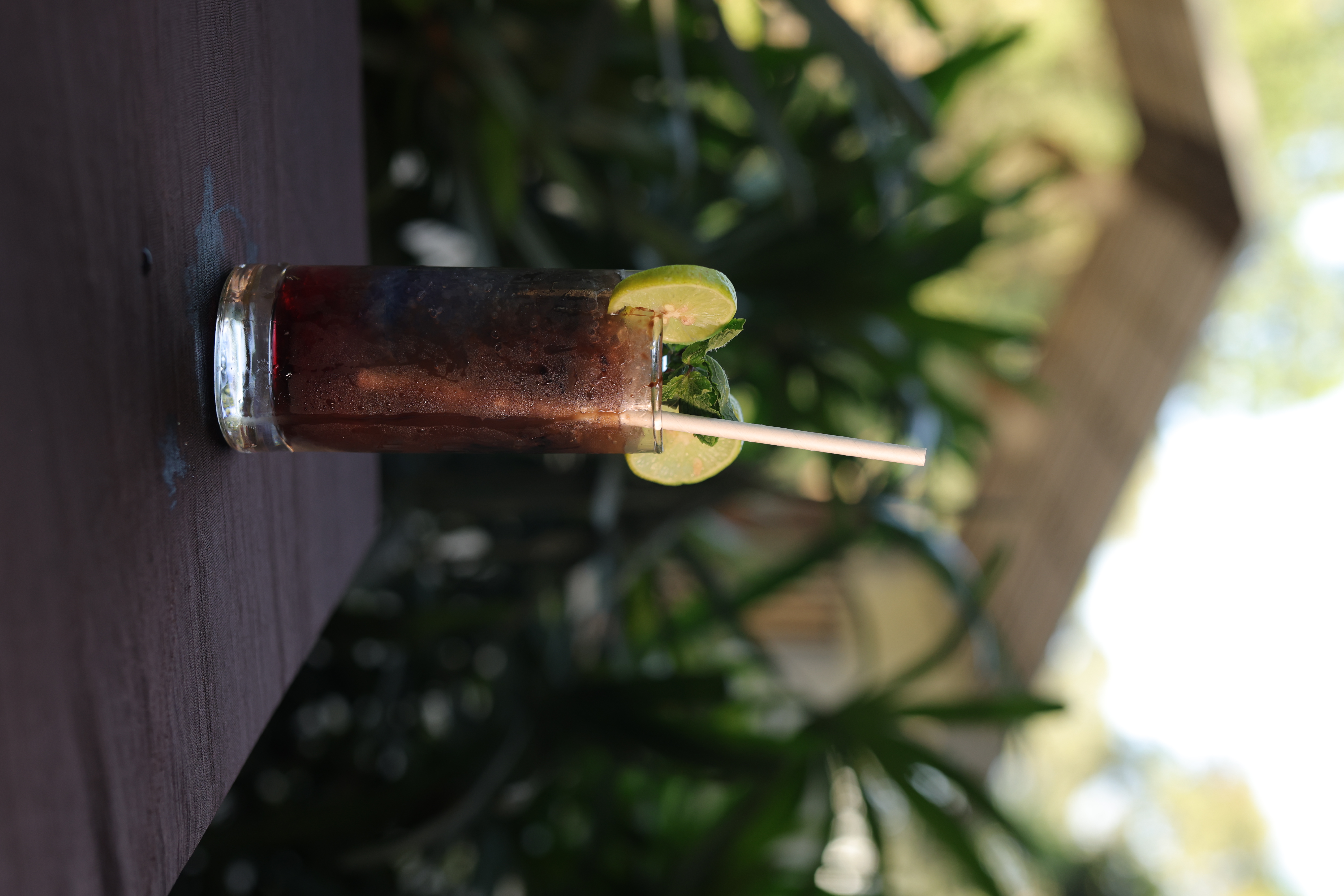 Dark iced cola mocktail with lime and mint at Jatra Countryside