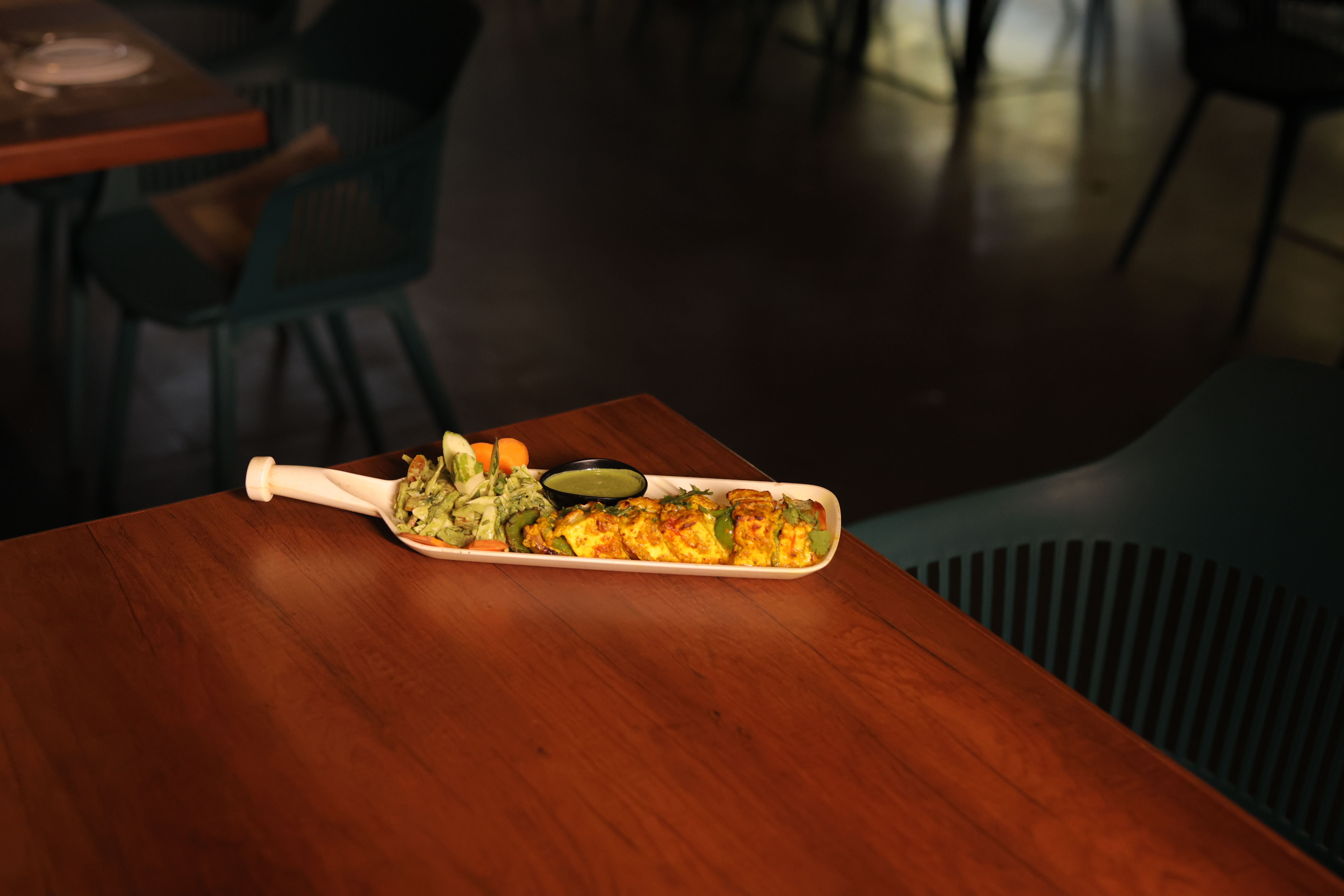Crispy golden starter served on a wooden board at Jatra Countryside